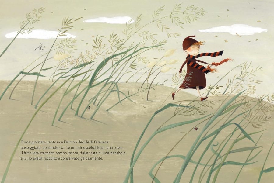 il filo rosso - immagine di un bambino vestito di rosso con una sciarpa arighe che passeggia in una campagna delicata
